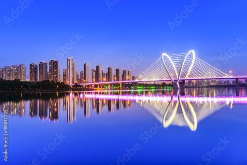 Modern bridge  and skyscraper at dusk. Located in Shenyang, Liaoning, China.