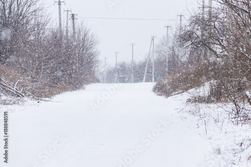 Snowy rural street during snowfall