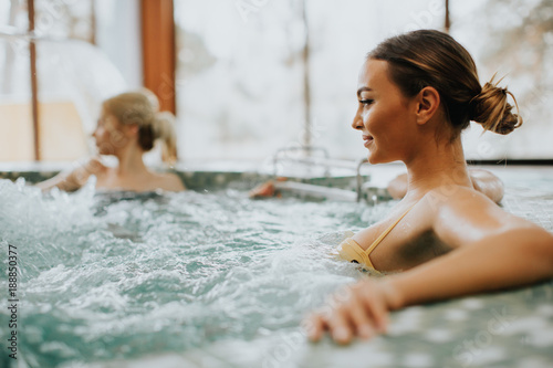 Young woman relaxing in the whirlpool bathtub photo