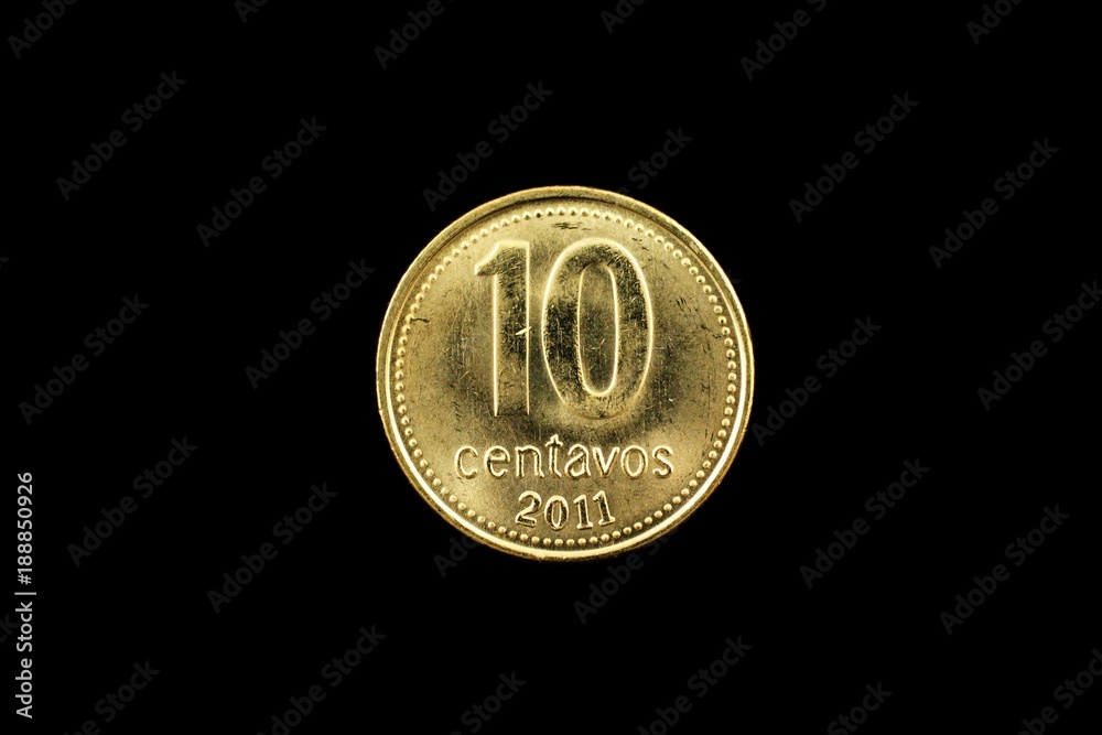 A super macro image of a gold argentinian ten centavo coin isolated on a black background A super macro image of a gold argentinian ten centavo coin isolated on a black background