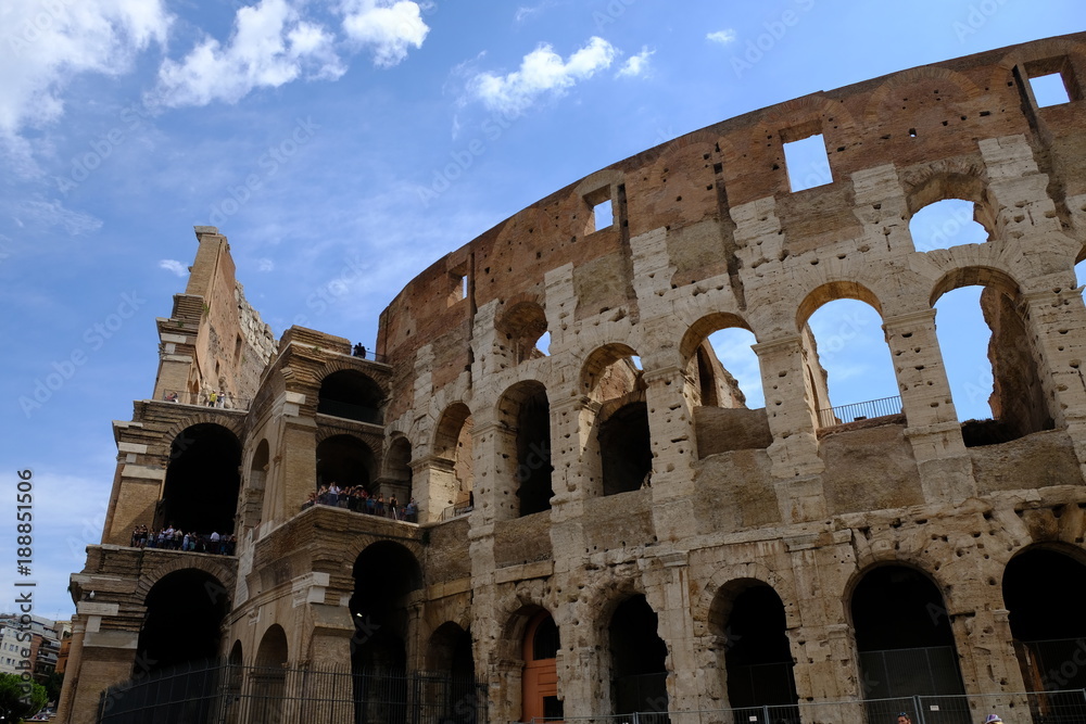 Ancient Roman wonder Coliseum, Colosseum or Colosseo. Details against blue sky