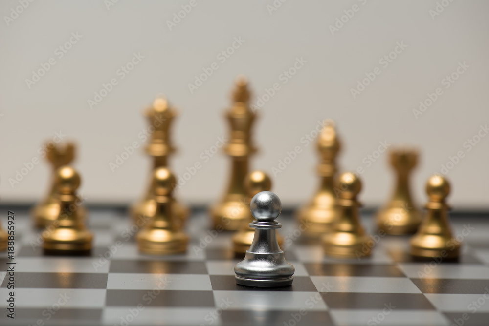 One chess pieces staying against full set of black chess pieces One chess pieces staying against full set of black chess pieces