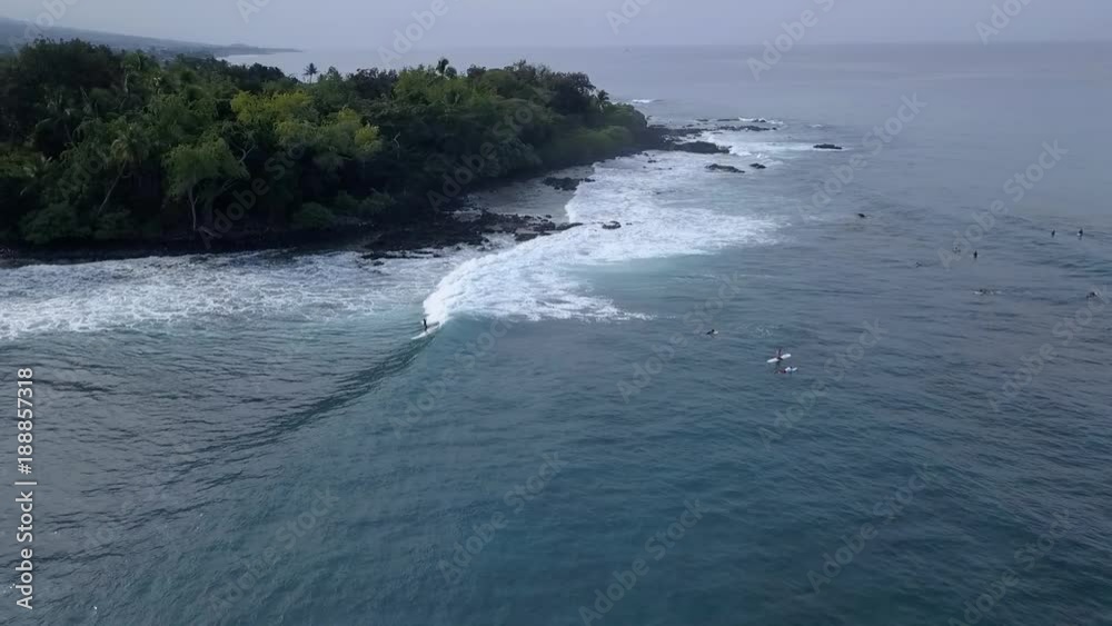 Aerial view of surfers off a rocky shore Aerial view of surfers off a rocky shore