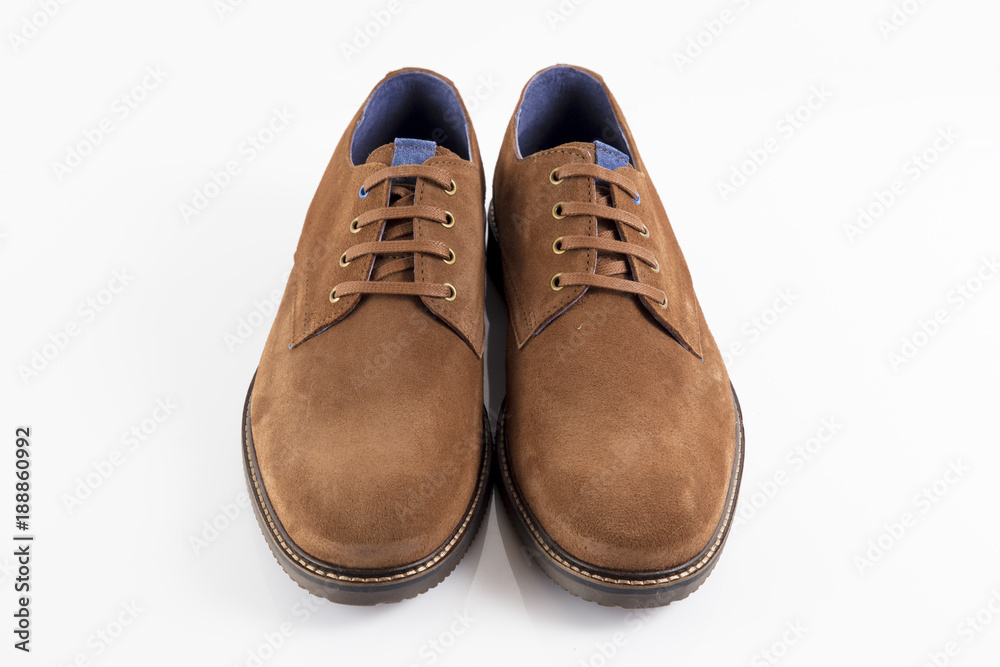 Male brown leather shoe on white background, isolated product, comfortable footwear. Male brown leather shoe on white background, isolated product, comfortable footwear.