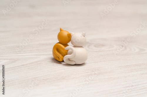 Obraz na płótnie Two minimalistic animal figures in love. Lovely cat plasticine models having tails in heart shape. Happy Valentine's Day. w salonie