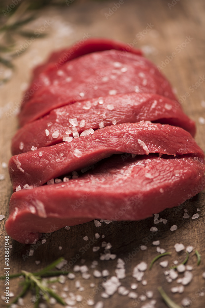 Raw beef steak on a dark wooden table. Raw beef steak on a dark wooden table.