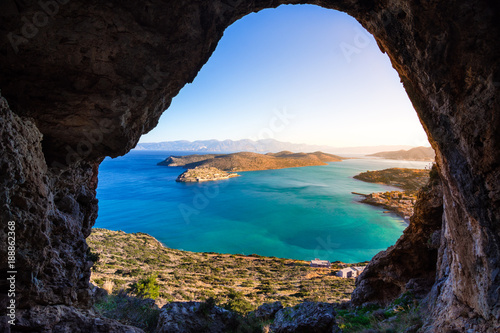 Panoramic view of the gulf of Elounda with Spinalonga island. View from the mountain through a cave, Crete, Greece. © gatsi
