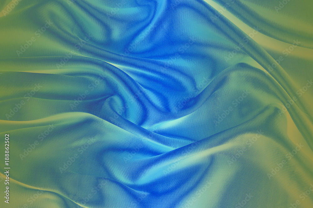 Obraz premium Light blue and green fabric with soft folds.