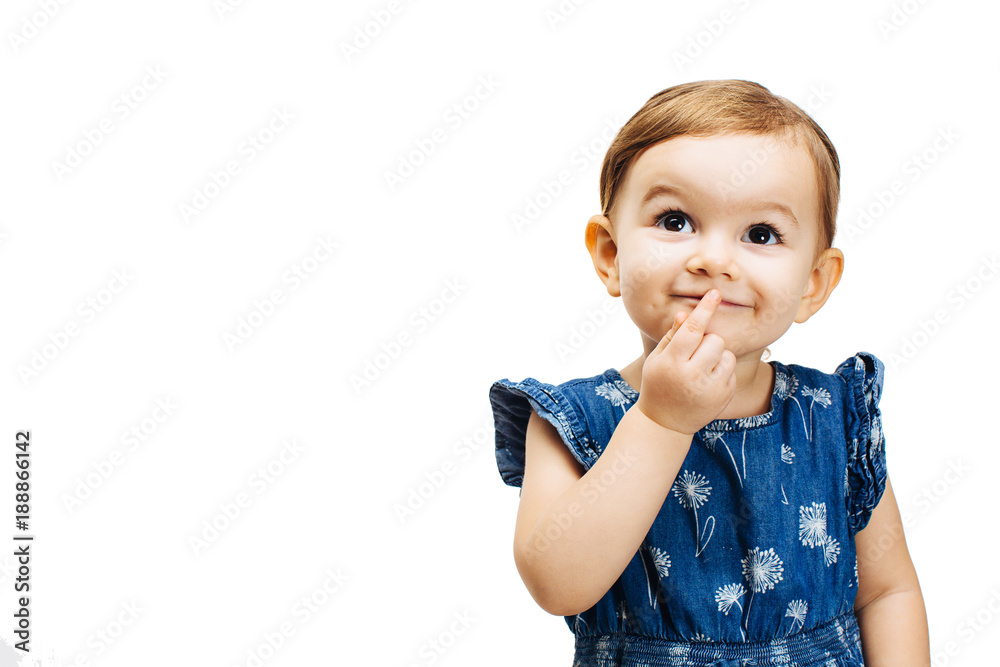 happy and curious toddler girl thinking with a finger on her mouth - obrazy, fototapety, plakaty 