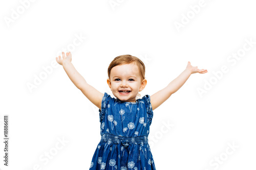 Foto Studio portrait of smiling girl with arms raised