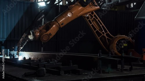 Timelapse of welding robot arm melt metal process at workshop. High Precision Modern Tools in Heavy Industry. Automatic work. Technology and Industrial Concept. Shot in 5K RAW