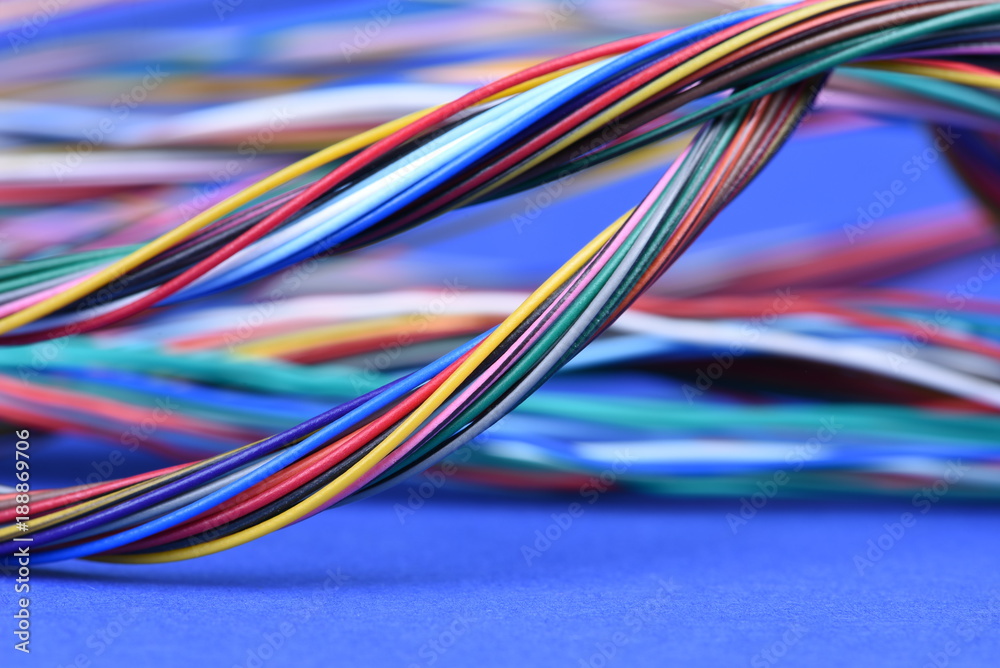 Colorful electrical cables on blue background
