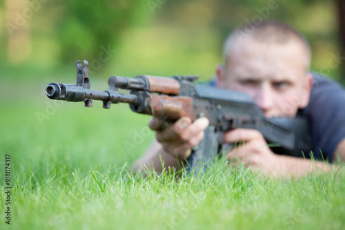 Man with Kalashnikov rifle took aim outdoors