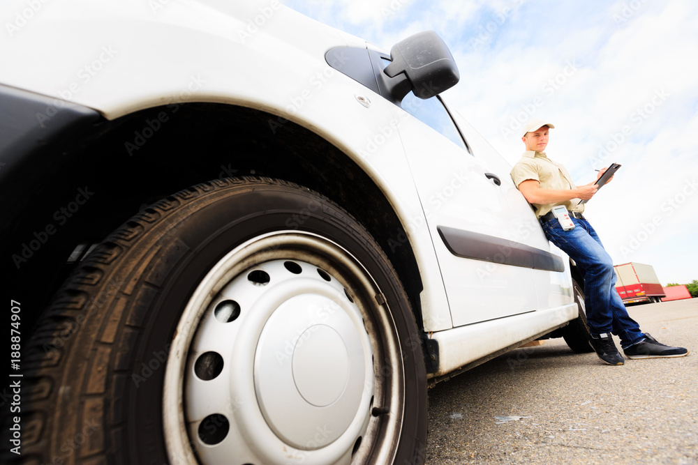 Fototapeta premium Delivery Boy Standing Next To His Van