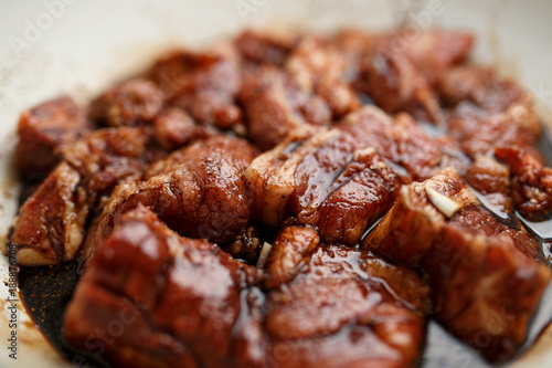 Fresh pork ribs marinated in the garnet sause narsharab. Close up.