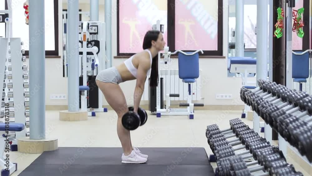 Bodybuilder doing exercise with a heavy weight bar inside gym