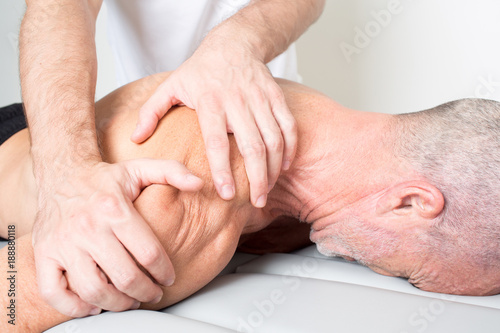 Massage therapist giving a shoulder massage photo
