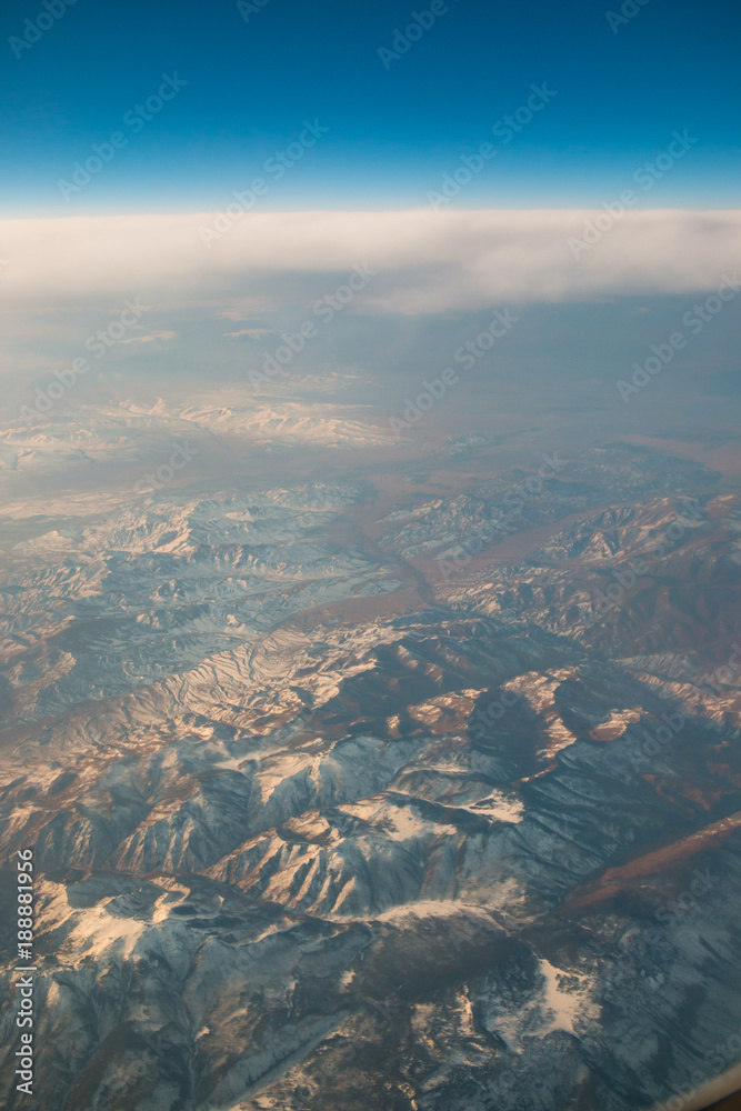 Aerial view of mountain from airplane window Aerial view of mountain from airplane window