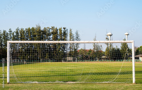 Soccer goal on field grass in morning photo