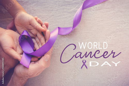 Hands holding Purple ribbons, toning copy space background, Alzheimer disease, Pancreatic cancer, Epilepsy awareness, domestic violence wareness photo