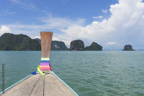 Long tail boat against blue sky in Phang Nga Bay, Thailand photo
