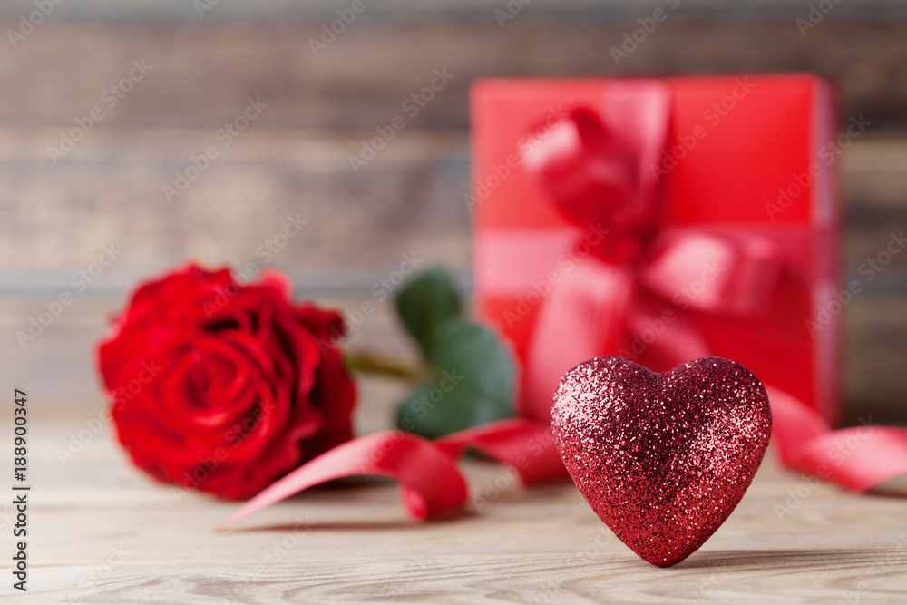 Greeting card for Mother or Valentines day. Heart, gift and rose flower on rustic wooden table. Greeting card for Mother or Valentines day. Heart, gift and rose flower on rustic wooden table.