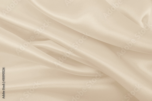 Smooth elegant golden silk or satin luxury cloth texture as wedding background. Luxurious Christmas background or New Year background design. In Sepia toned. Retro style