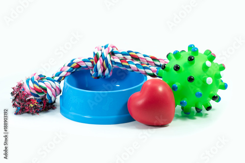Pets are friends concept.  Pet bowl and rubber toys with rope for dog or cat isolated on white background.