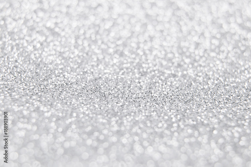 White and silver glitter background. Selective focus. Winter christmas background. Happy new year and christmas concept.