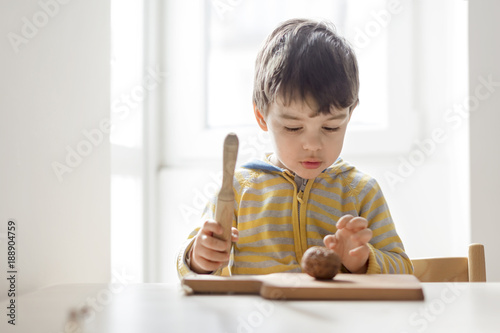 Young boy about to break walnut