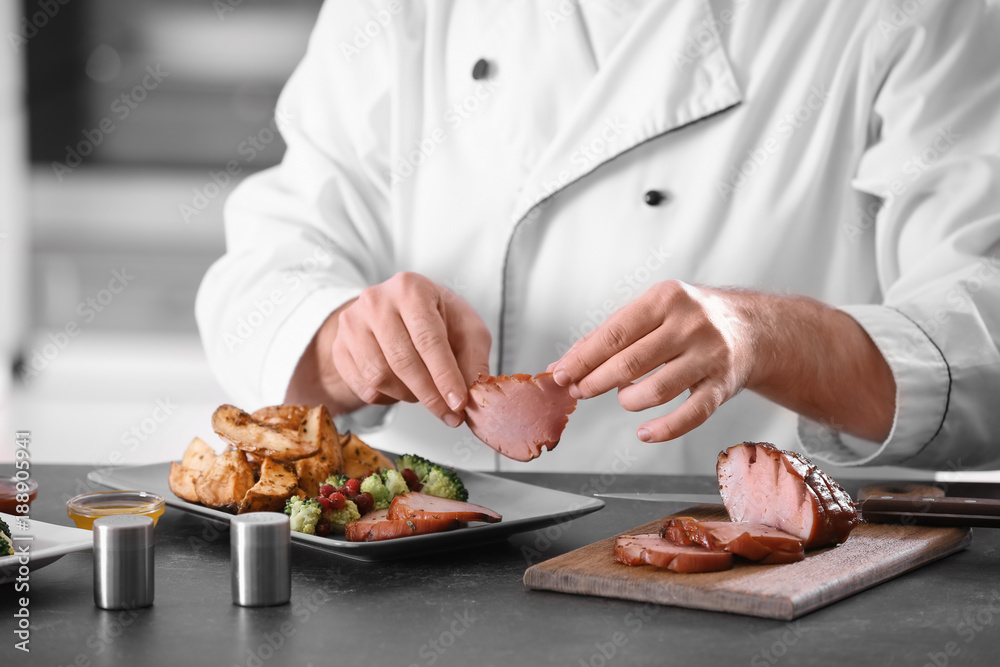 Chef serving delicious honey baked ham on plate