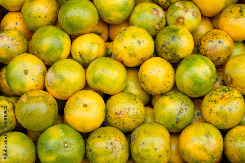 Orange fruits soiled organic stacked on wood crate in grocery Orange fruits soiled organic stacked on wood crate in grocery