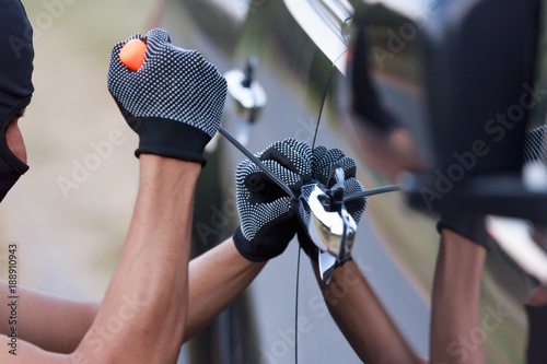 Thieves trying to open The car door.Security concept.