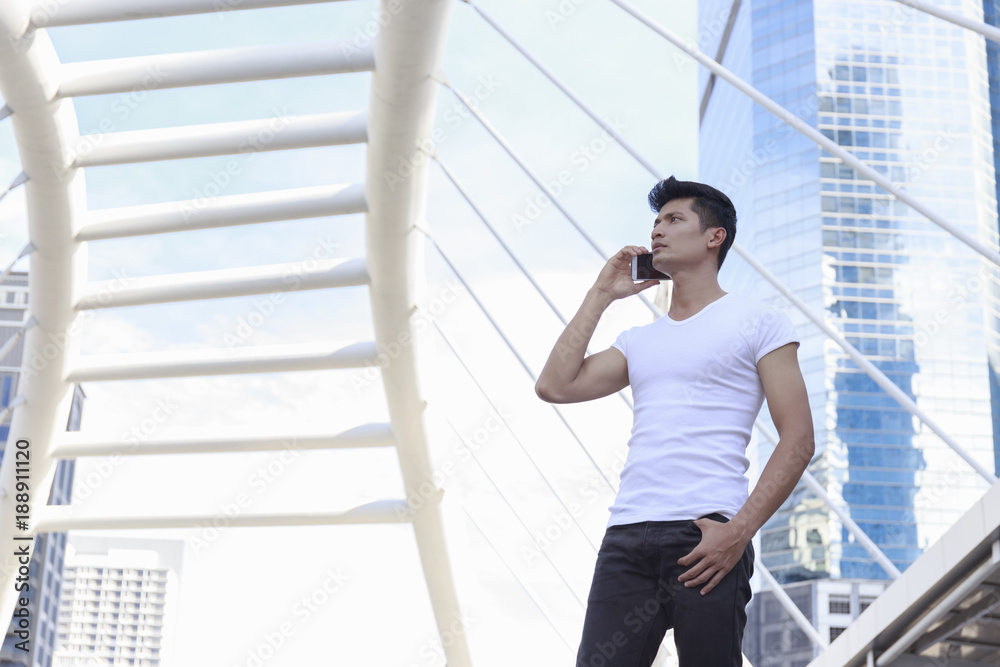 Young man talking on the phone in downtown.