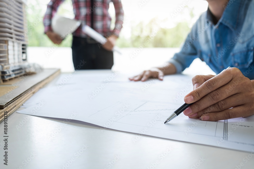 Architect working on blueprint, Engineer working with engineering tools for architectural project on workplace Architect working on blueprint, Engineer working with engineering tools for architectural project on workplace