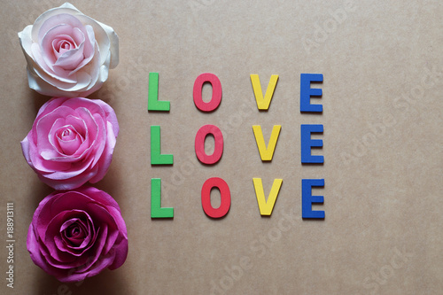 Love word and roses pattern on brown paper background.