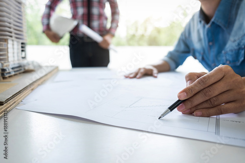 Architect working on blueprint, Engineer working with engineering tools for architectural project on workplace