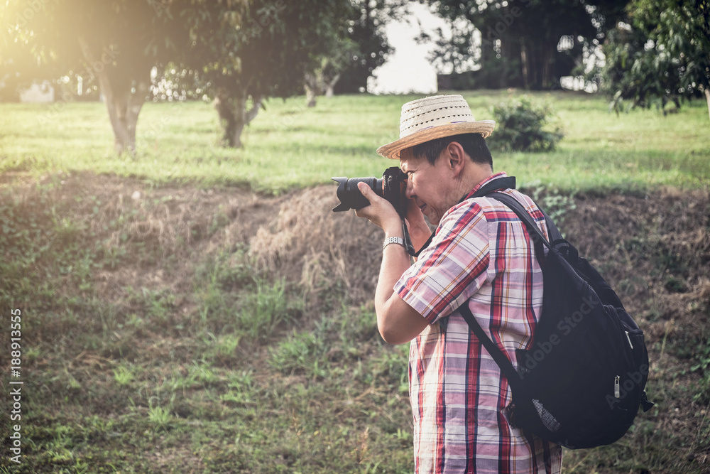 Older man backpacking travel are taking photo