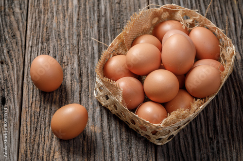 Brown Egg in a basket on wooden table, Chicken Egg