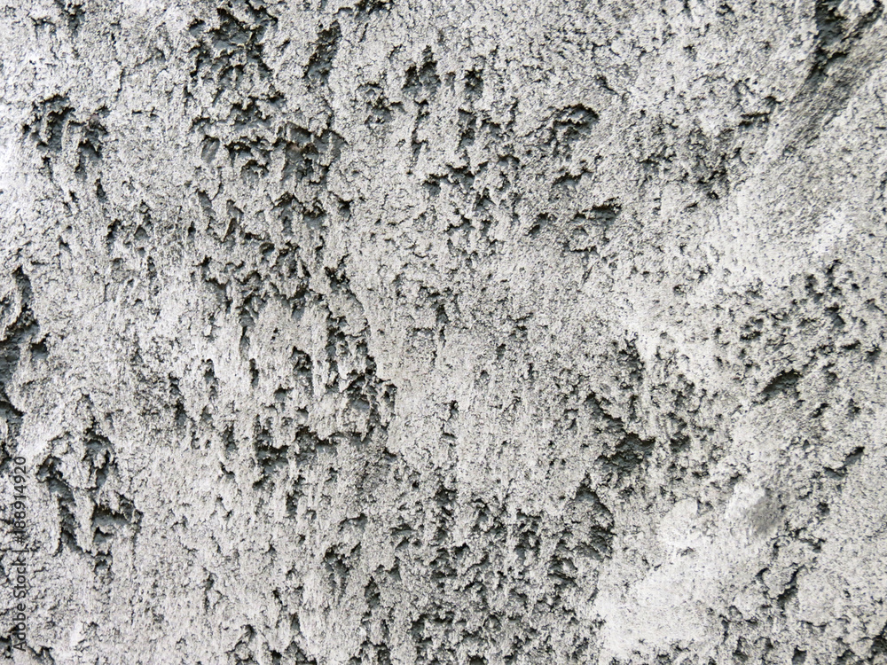 texture plaster,  loft style, wall of the building plastered black and white stucco with glitter in the Venetian technique, travertine stone, l