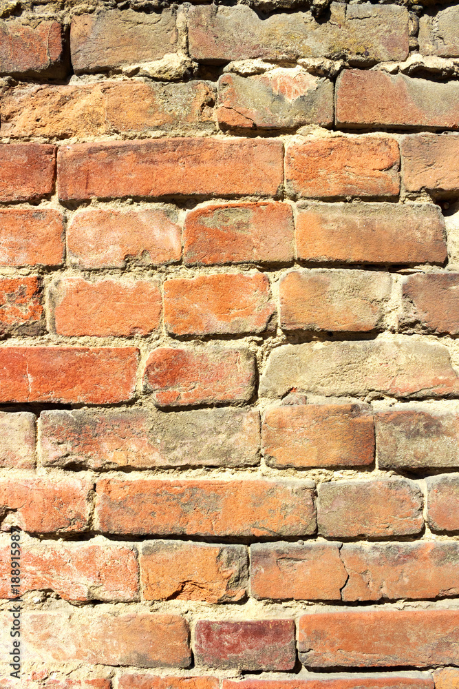 Fototapeta premium Vertical background of old vintage red brick wall