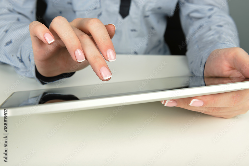 Fototapeta premium Woman using a touch screen tablet hands
