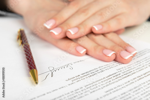 Woman hand signing a contract