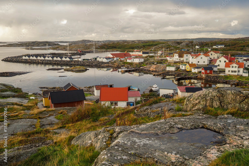 A small village in the countryside. Colorful houses along shoreline of an archipelago