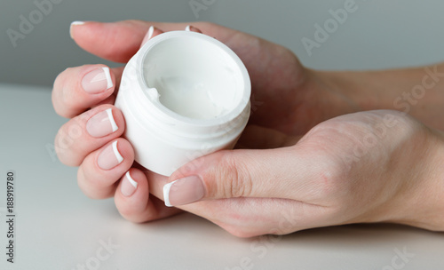 beautiful woman hands with cream