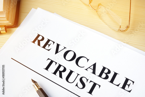 Revocable trust on a wooden desk. photo