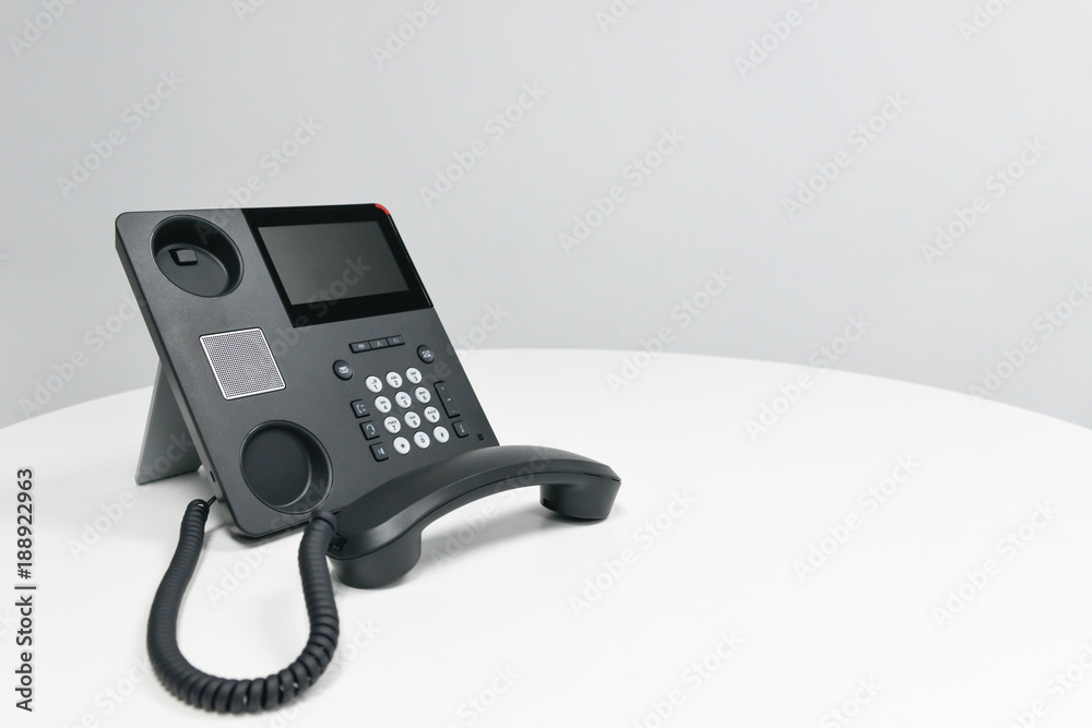 Black IP Phone, Office phone on the white table in the meeting room Black IP Phone, Office phone on the white table in the meeting room