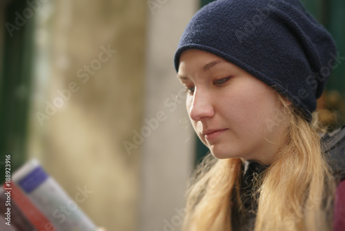 portrait of teen girl looking at map on street