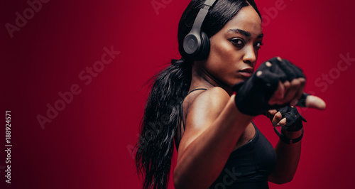 Fotografie, Tablou Strong young woman practising boxing