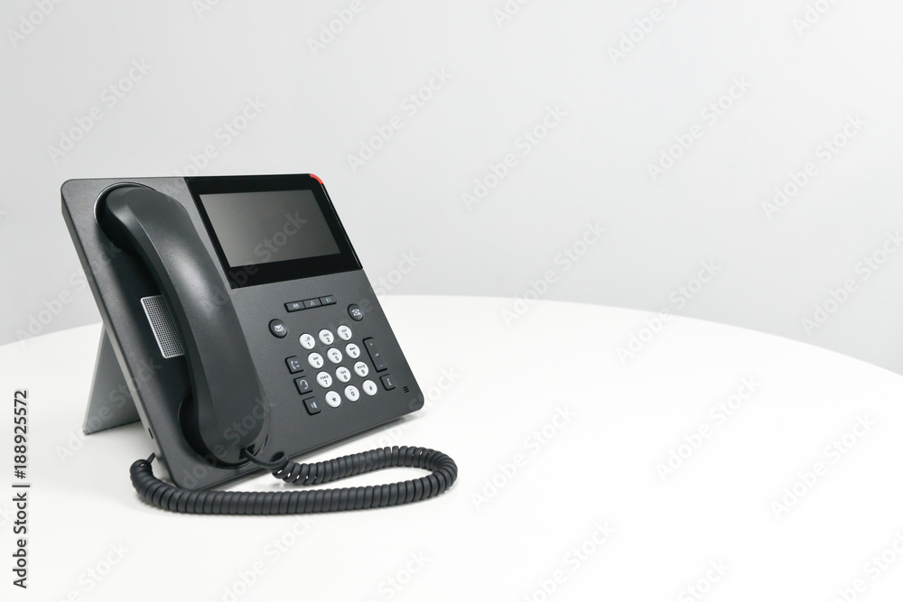 Black IP Phone, Office phone on the white table in the meeting room Black IP Phone, Office phone on the white table in the meeting room